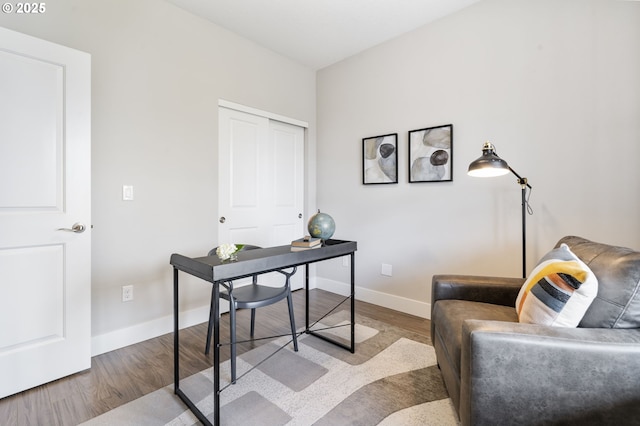 office area featuring baseboards and wood finished floors
