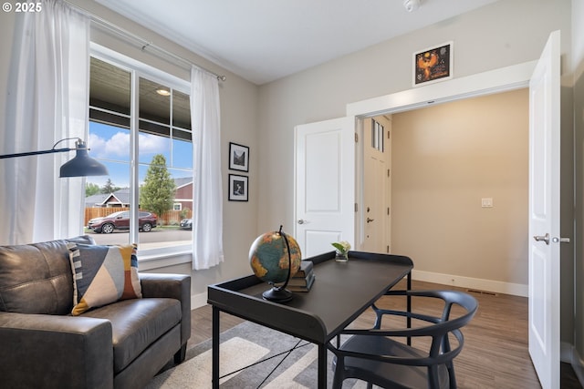 office featuring baseboards and wood finished floors