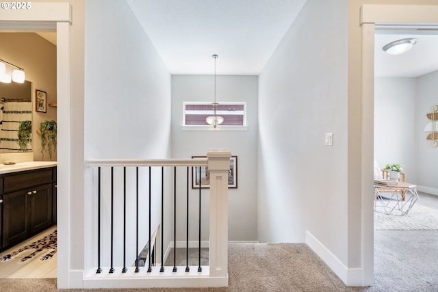 stairway featuring carpet and baseboards