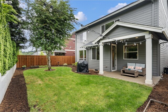 back of property featuring an outdoor living space and a patio