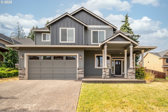 3100 NE 171st St, Ridgefield, WA 98642 - craftsman-style house featuring stone siding, board and batten siding, concrete driveway, and a porch