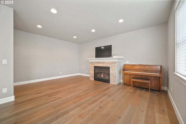 3100 NE 171st St, Ridgefield, WA 98642 - unfurnished living room featuring light wood-style floors, a tiled fireplace, and recessed lighting