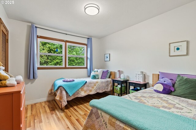 7005 SW 14th Ave, Portland, OR 97219 - bedroom with light wood-type flooring, baseboards, and vaulted ceiling