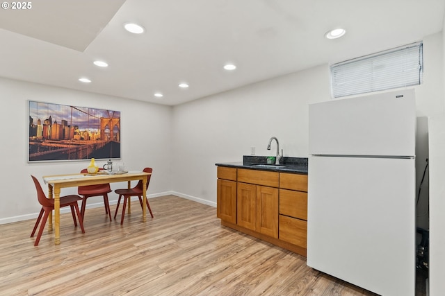 7005 SW 14th Ave, Portland, OR 97219 - kitchen with freestanding refrigerator, a sink, light wood-style floors, recessed lighting, and brown cabinetry