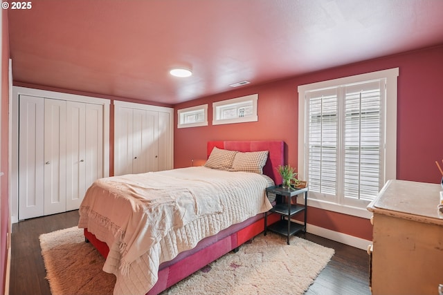 7913 SE Henderson St, Portland, OR 97206 - bedroom featuring multiple closets, wood finished floors, and multiple windows