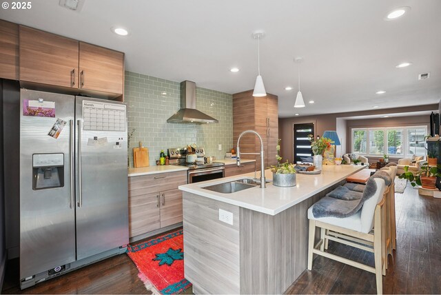 7913 SE Henderson St, Portland, OR 97206 - kitchen featuring stainless steel appliances, wall chimney exhaust hood, light countertops, modern cabinets, and backsplash