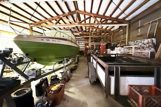 misc room featuring lofted ceiling and concrete flooring