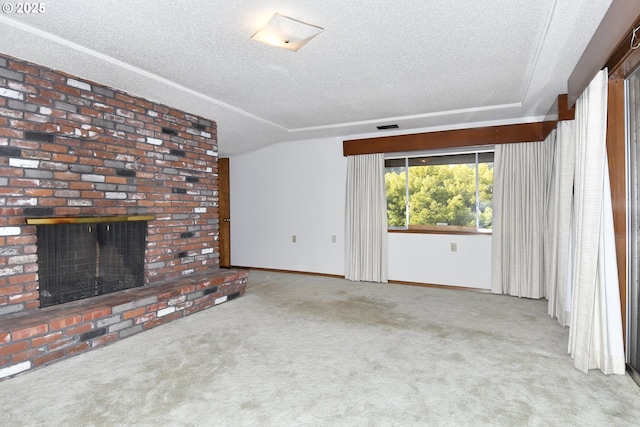 unfurnished living room with a brick fireplace, light colored carpet, and a textured ceiling