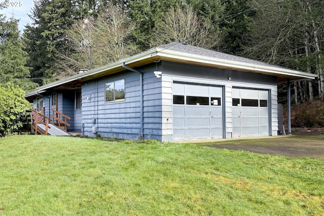 garage featuring a lawn