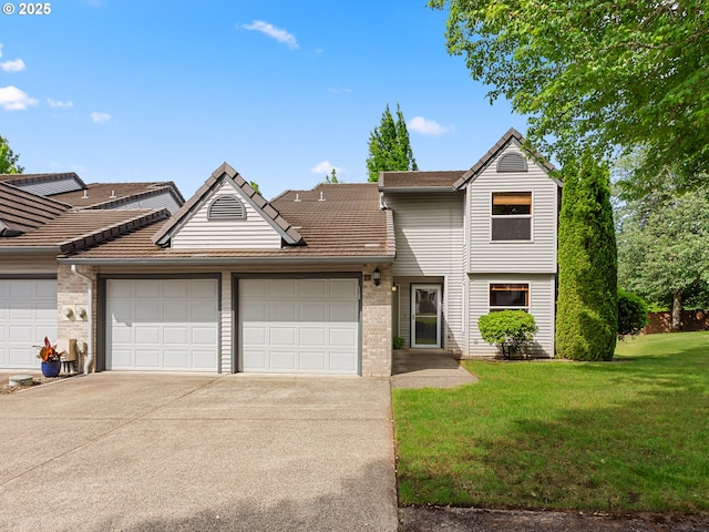 15917 NE Union Rd Unit 103, Ridgefield, WA 98642 - view of front facade featuring a garage, driveway, a front lawn, and brick siding