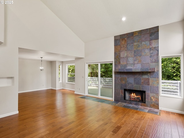 15917 NE Union Rd Unit 103, Ridgefield, WA 98642 - unfurnished living room featuring high vaulted ceiling, a fireplace, and wood finished floors
