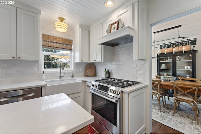 20525 Martin Ct, West Linn, OR 97068 - kitchen with stainless steel appliances, dark wood-style flooring, light stone countertops, white cabinets, and decorative backsplash