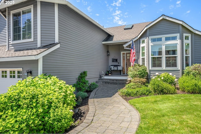 20525 Martin Ct, West Linn, OR 97068 - property entrance with an attached garage, a shingled roof, and a yard