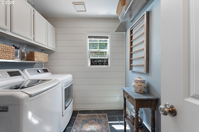 20525 Martin Ct, West Linn, OR 97068 - laundry room with cabinet space, washing machine and clothes dryer, wooden walls, and dark tile patterned flooring