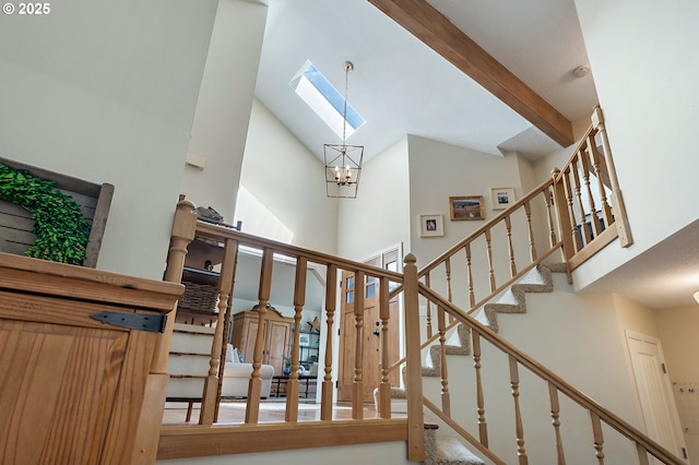 20525 Martin Ct, West Linn, OR 97068 - stairs with a towering ceiling, a skylight, a chandelier, and beamed ceiling