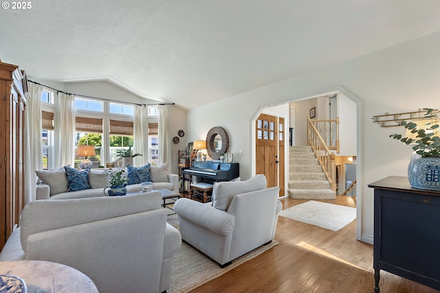 20525 Martin Ct, West Linn, OR 97068 - living area with vaulted ceiling, light wood-type flooring, stairway, and a textured ceiling