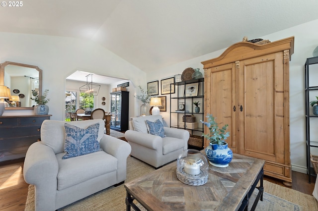 20525 Martin Ct, West Linn, OR 97068 - living area featuring lofted ceiling, wood finished floors, arched walkways, and a chandelier