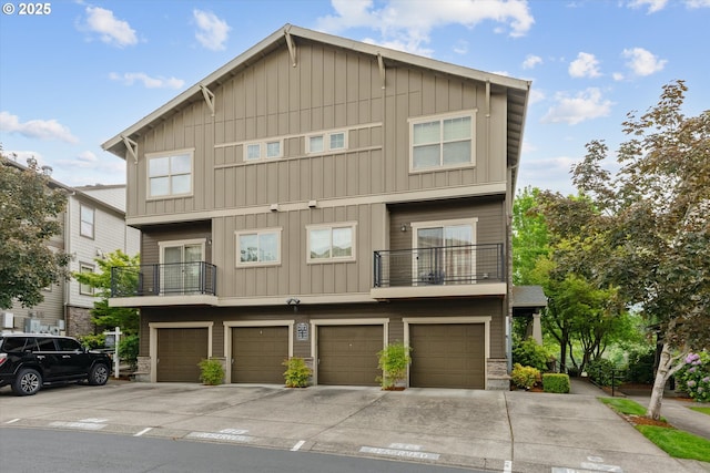 630 NE Adwick Dr, Hillsboro, OR 97006 - view of property featuring board and batten siding, a balcony, driveway, and a garage