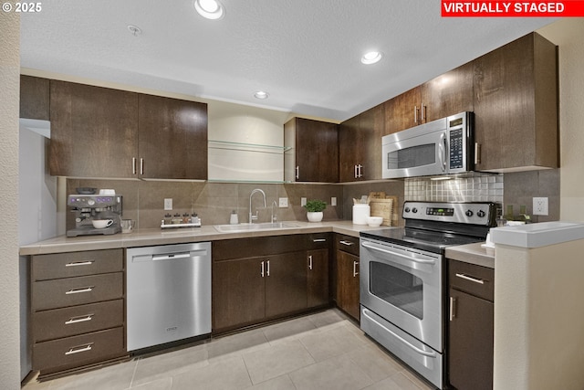 630 NE Adwick Dr, Hillsboro, OR 97006 - kitchen with stainless steel appliances, a sink, tasteful backsplash, light countertops, and recessed lighting