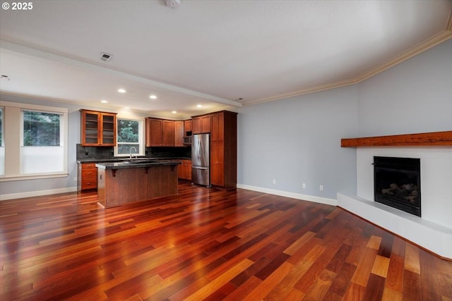 kitchen featuring dark hardwood / wood-style flooring, sink, stainless steel fridge, and a center island