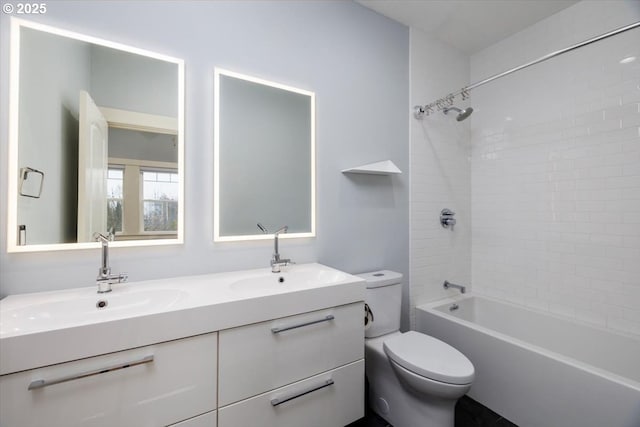 full bathroom with vanity, tiled shower / bath combo, and toilet