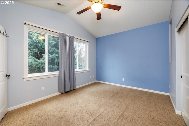 unfurnished bedroom with ceiling fan, lofted ceiling, and carpet flooring