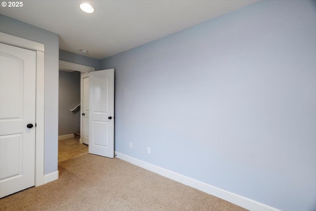 unfurnished bedroom with light colored carpet