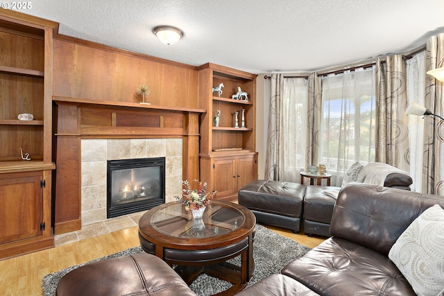 16506 NE 13th St, Vancouver, WA 98684 - living room with a textured ceiling, a tile fireplace, and light wood-style flooring