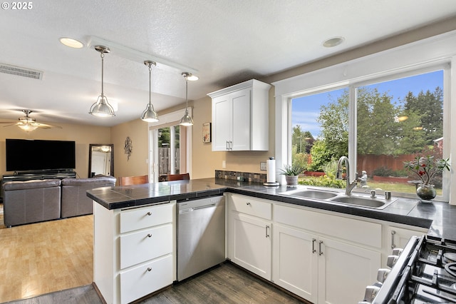 16506 NE 13th St, Vancouver, WA 98684 - kitchen with stainless steel appliances, a peninsula, tile countertops, ceiling fan, and white cabinets