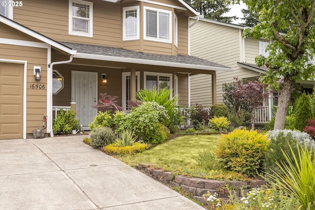 16506 NE 13th St, Vancouver, WA 98684 - view of front of home featuring a garage, a porch, a front lawn, concrete driveway, and a shingled roof