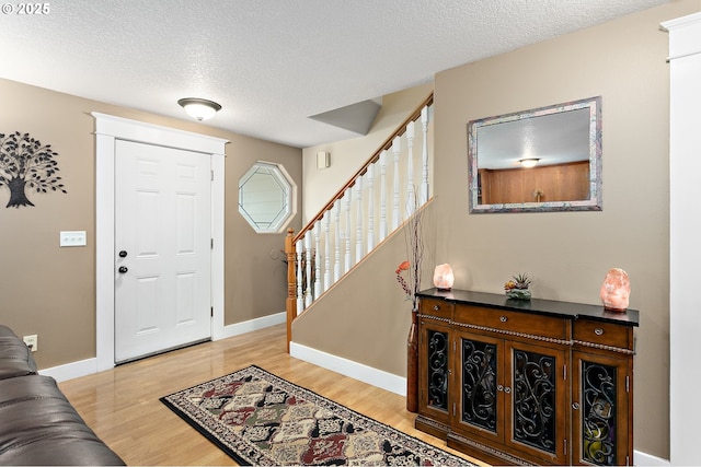 16506 NE 13th St, Vancouver, WA 98684 - foyer featuring stairway, light wood-style flooring, and a textured ceiling