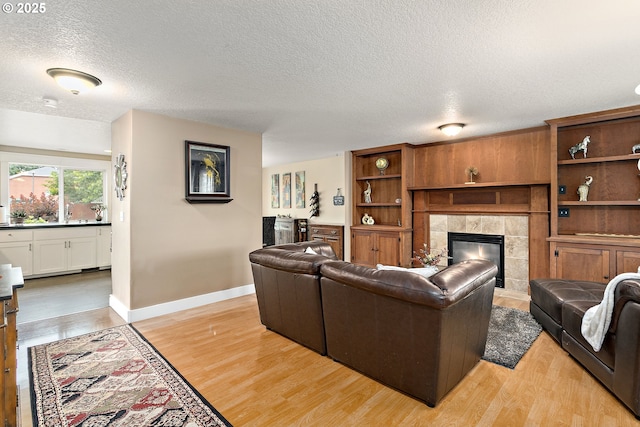 16506 NE 13th St, Vancouver, WA 98684 - living area with a textured ceiling, a fireplace, and light wood finished floors
