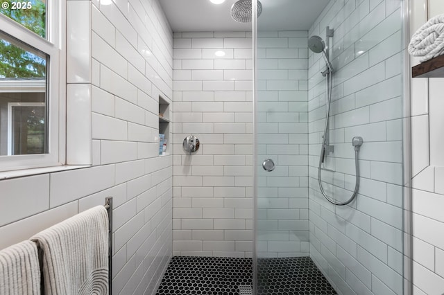 bathroom with tiled shower