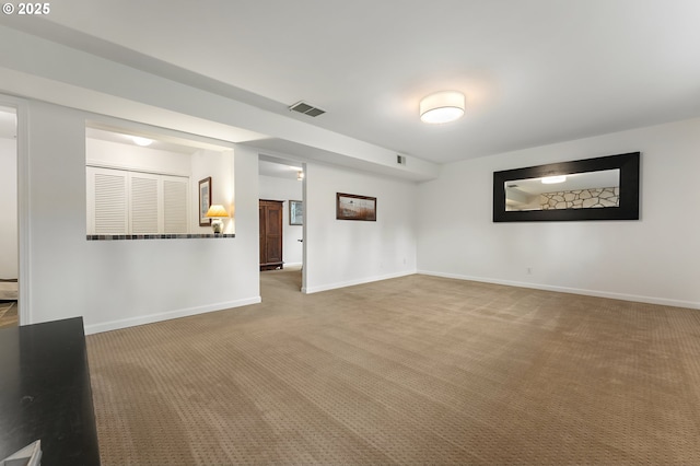 unfurnished living room featuring carpet, visible vents, and baseboards