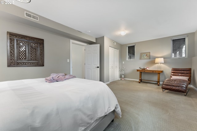 bedroom featuring carpet flooring, baseboards, visible vents, and a closet