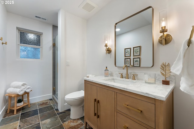 bathroom with visible vents, toilet, a stall shower, and vanity