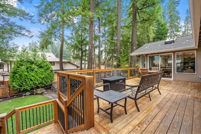 wooden terrace featuring a lawn and fence