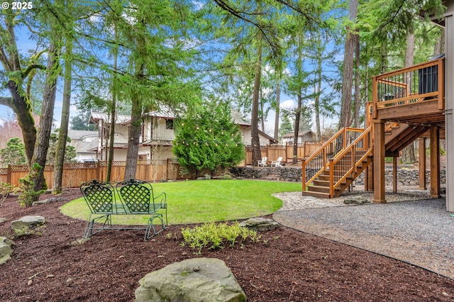 view of yard featuring stairway, a wooden deck, and a fenced backyard