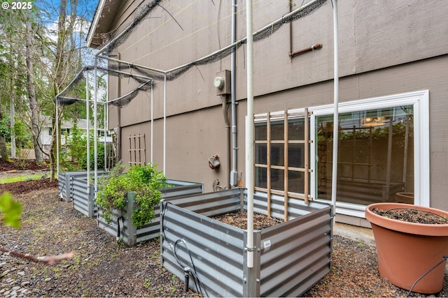 exterior space featuring electric meter and a garden