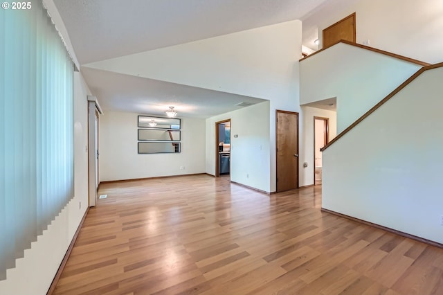121 SE 34th Cir, Troutdale, OR 97060 - unfurnished living room featuring light wood-type flooring and a towering ceiling