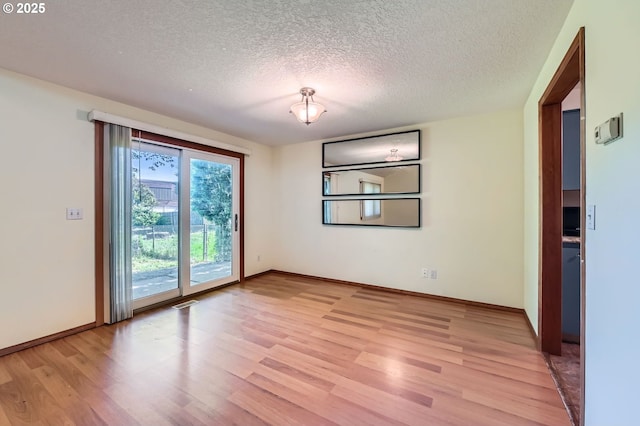 121 SE 34th Cir, Troutdale, OR 97060 - empty room with light wood-style floors and a textured ceiling