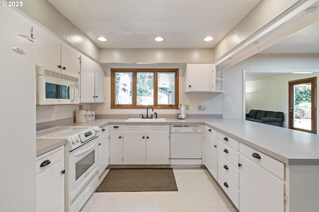 16390 SE Hillside Ln, Milwaukie, OR 97267 - kitchen with white appliances, a peninsula, light countertops, white cabinetry, and light tile patterned floors