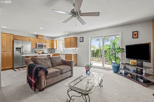 1227 Trent Ave, Keizer, OR 97303 - living room featuring healthy amount of natural light, light colored carpet, a textured ceiling, recessed lighting, and ceiling fan