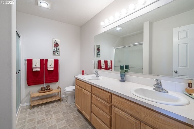 1227 Trent Ave, Keizer, OR 97303 - bathroom featuring a stall shower, toilet, double vanity, and baseboards