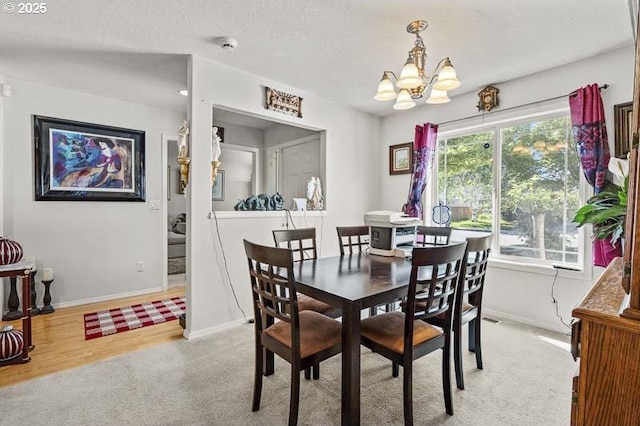 1227 Trent Ave, Keizer, OR 97303 - dining area featuring a chandelier, baseboards, and light carpet