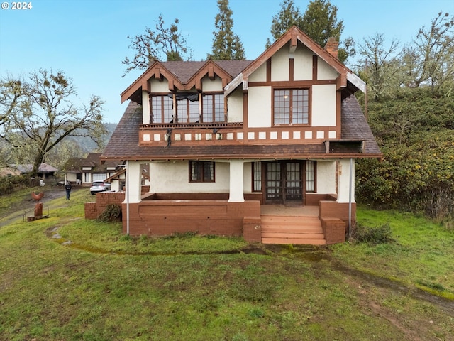 view of front facade featuring french doors and a front lawn