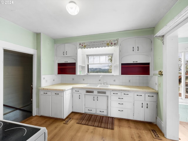 kitchen with white cabinetry, tile counters, and white range with electric stovetop