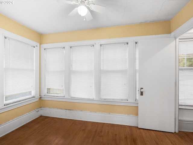 unfurnished sunroom featuring ceiling fan