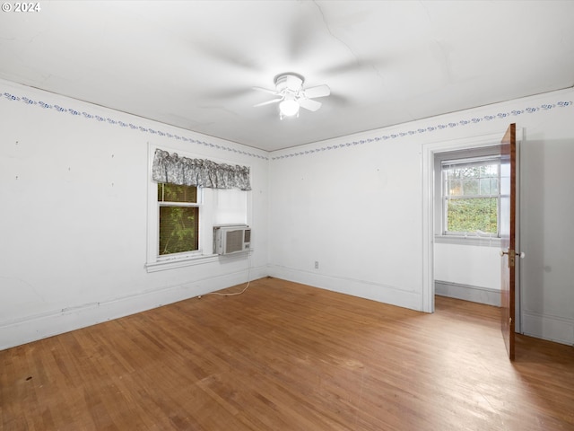 unfurnished room with hardwood / wood-style flooring, ceiling fan, and cooling unit