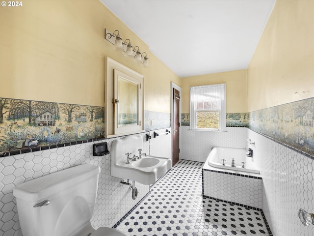 bathroom featuring toilet, tile patterned flooring, sink, and tile walls